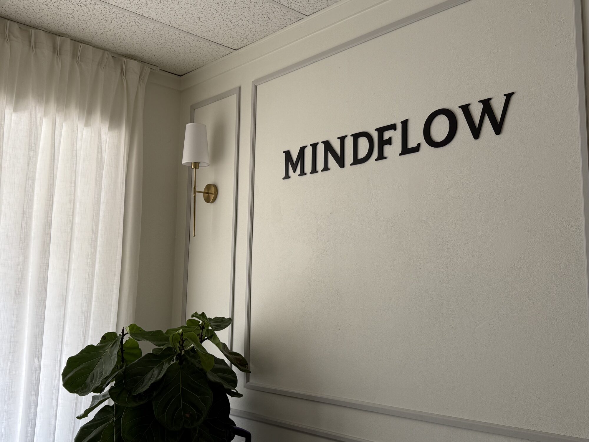 MindFlow Pilates studio reformer room with backlit arched mirrors